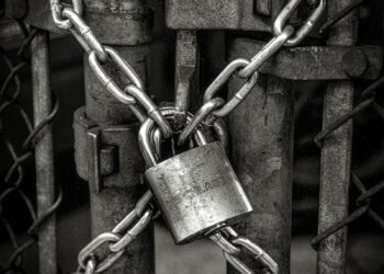 gray steel chain locked on gate