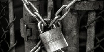 gray steel chain locked on gate