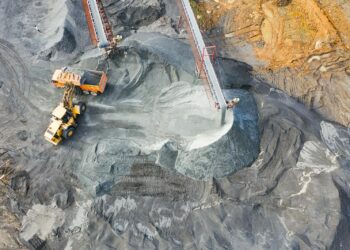 A top-down view showcasing mining operations with excavators and conveyor belts.